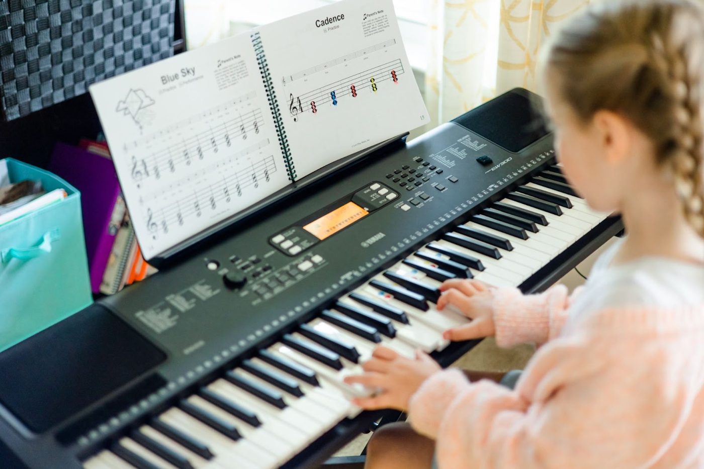 Two girls playing a keyboard together