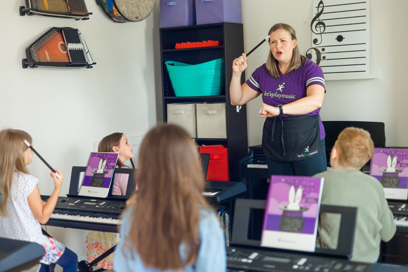Children at keyboards in a Let's Play Music class