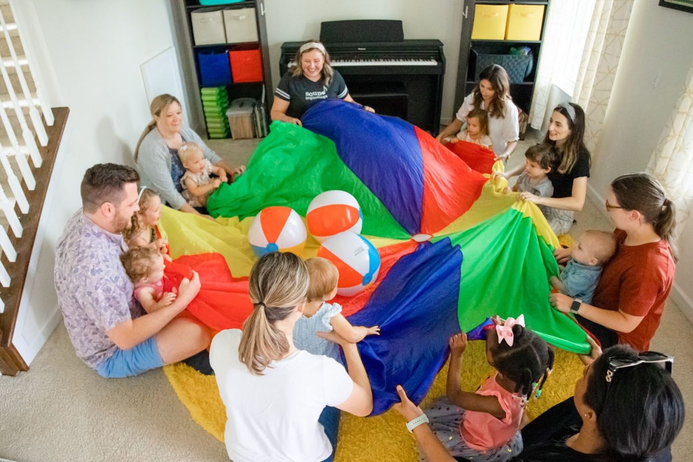 Families playing with a parachute in music class